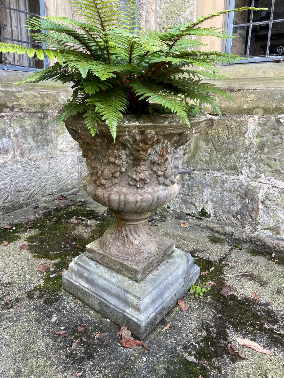 A pair of reconstituted stone garden urns